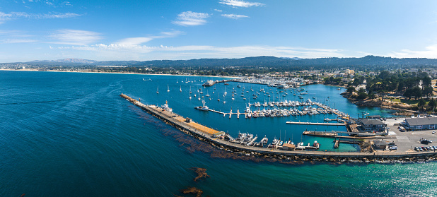 Beautiful aerial view of the Monterey town in California with many yachts docked by the pier.