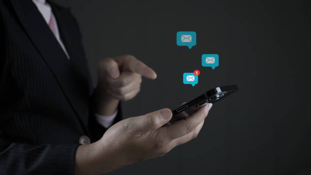 istock business woman hands using Laptop typing on keyboard and surfing the internet on office table with email icon, email marketing concept, send e-mail or news letter, online working internet network,red mail icon. 1909855257
