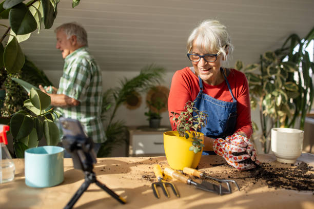 istock Senior woman vlogging on gardening 1909866301