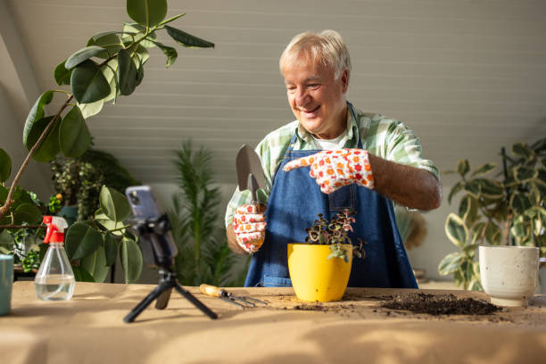 istock Senior man vlogging on gardening 1909866629