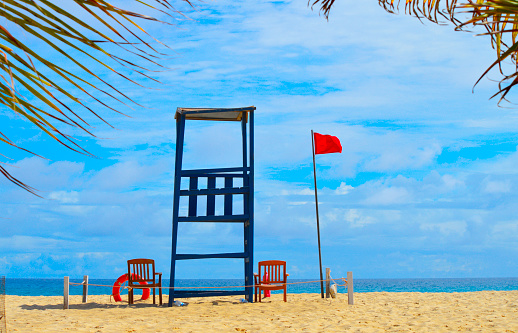 Life guards station on Boa Vista beach, in Cape Verde Africa facing the Atlantic Ocean showing a red flag