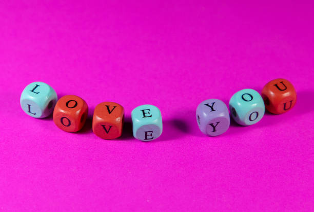 istock Phrase Love You written with colorful cubic beads 1909872125