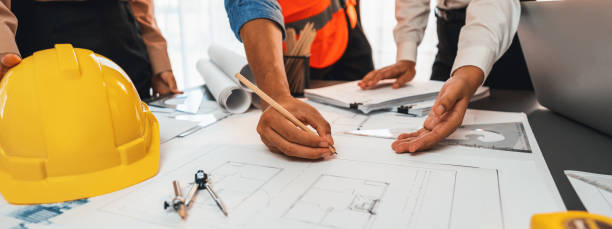 istock Engineer partner drawing and working on blueprint design together. Insight 1909874227