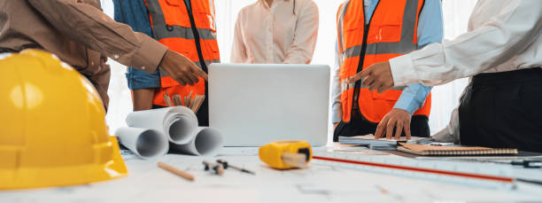 istock Engineer partner drawing and working on blueprint design together. Insight 1909880609
