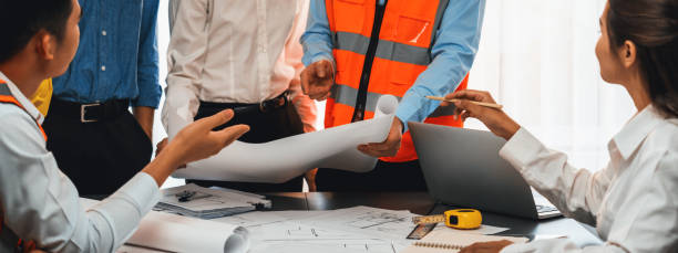 istock Engineer partner drawing and working on blueprint design together. Insight 1909889581