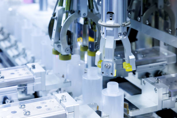 istock robot arm moving plastic bottle to conveyor belt of auto capping and labeling machine at cosmetic and skin care manufacturing. cosmetic industry and ai technology machinery concept. 1909890089