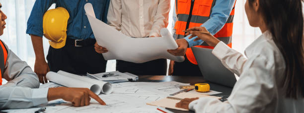 istock Engineer partner drawing and working on blueprint design together. Insight 1909893773