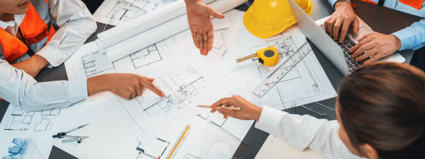 istock Engineer partner drawing and working on blueprint design together. Insight 1909897466
