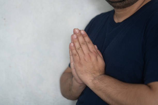 Asian man raise hands to pay respect or sawasdee. Lifestyle thai people concept