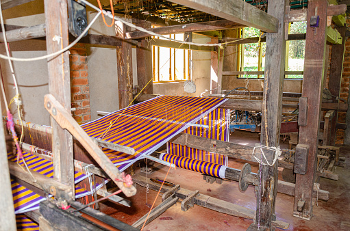 Cotton weaving on a traditional wooden handloom.
