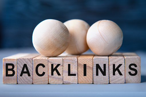 BACKLINKS - word on wooden blocks on dark blue background