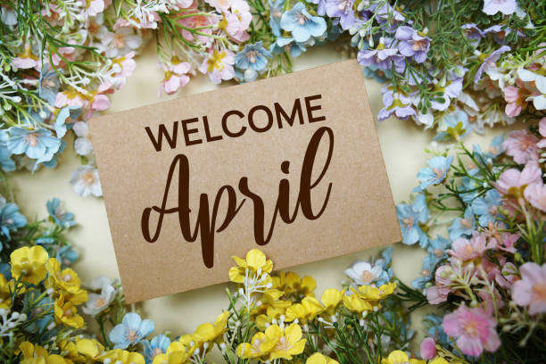 istock Welcome April text message with flower decoration on yellow background 1909939237