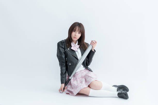 istock Asian school girl holding a bat 1909947093