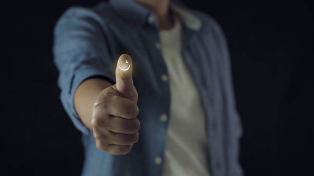istock Customer satisfaction concept. Hand with thumb up Positive emotion smiley face icon 1909966076