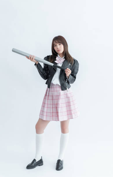 istock Asian school girl holding a baseball bat 1909966612