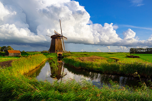 Dutch Windmill along a  Canal near Schermerhorn, Netherlands
