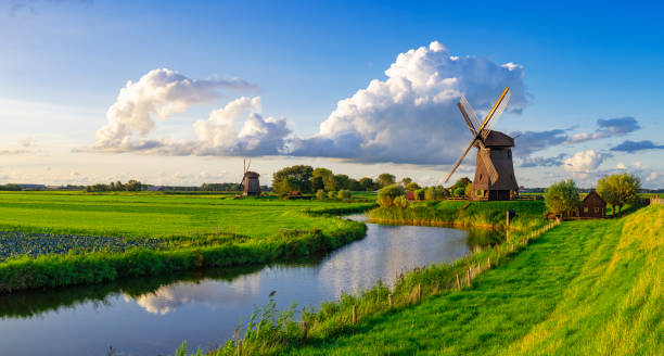 Dutch Windmill along a  Canal near Schermerhorn, Netherlands Dutch Windmill along a  Canal near Schermerhorn, Netherlands netherlands windmill stock pictures, royalty-free photos & images