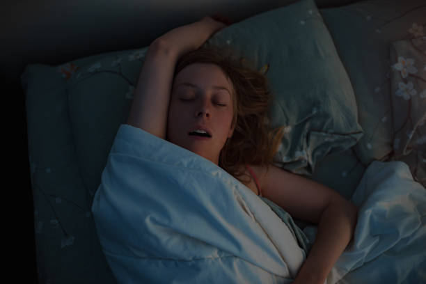 istock Young beautiful woman sleeping in bed at early morning 1909978596