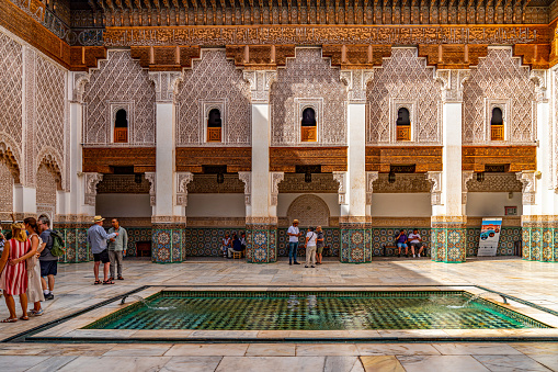 Tourists are visiting Ben Youssef Mosque, Marrakech, Morocco.