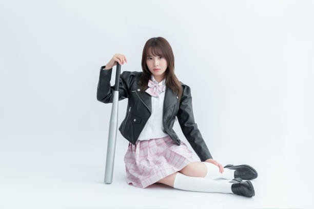istock Asian school girl holding a baseball bat 1909982823
