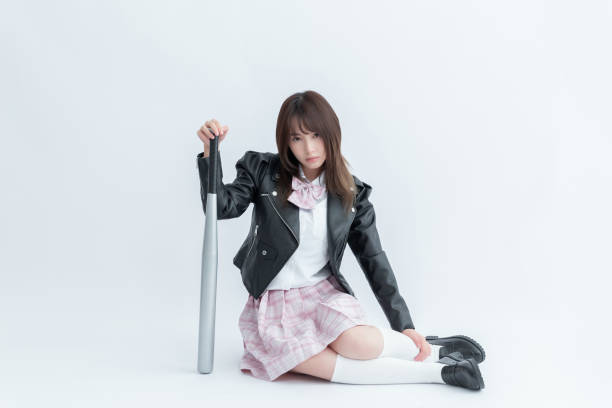 istock Asian school girl holding a baseball bat 1909987551