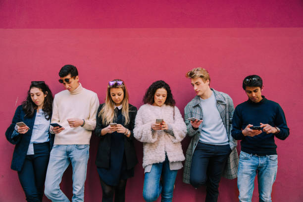 istock Young friends on mobile phone 1910004936