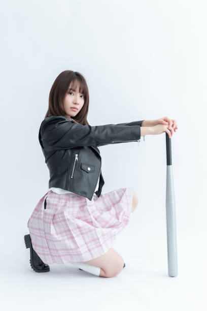 istock Asian school girl holding a baseball bat 1910008083