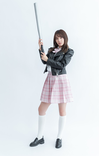Asian school girl holding a bat