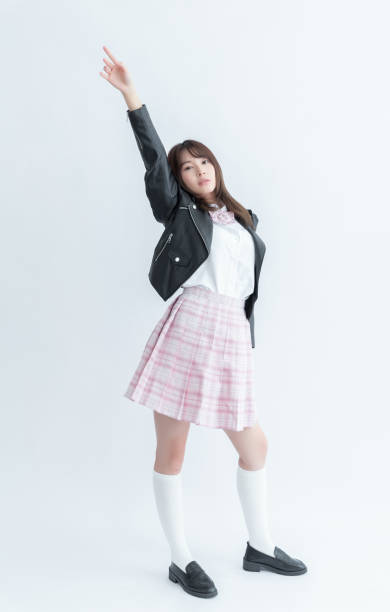 istock Cheerful Asian school girl in uniform 1910037974