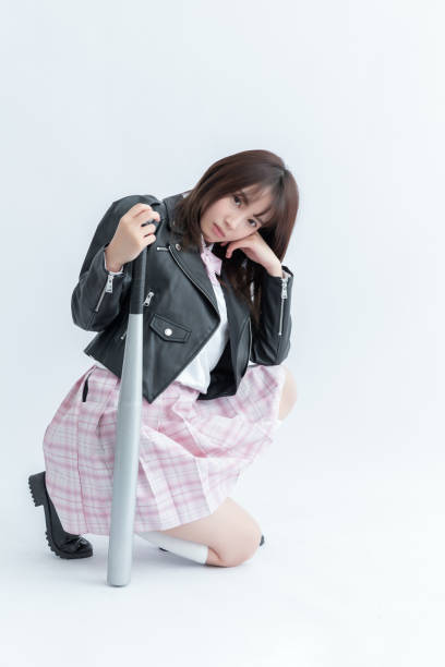 istock Asian school girl holding a bat 1910048505