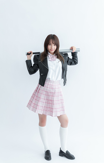 Asian school girl holding a baseball bat