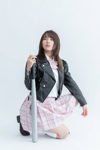 Asian school girl holding a baseball bat
