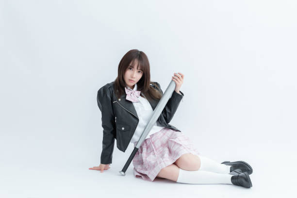 istock Asian school girl holding a bat 1910063130