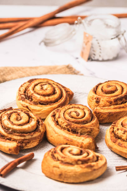 istock Homemade cinnamon rolls on white plate on white marble background 1910073048