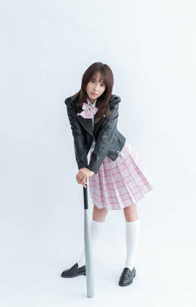 istock Asian school girl holding a bat 1910078249