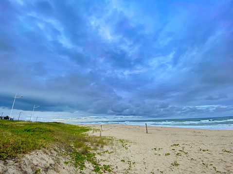 Beautiful beach landscape on a cloudy day with rain. Photo taken on Enseada beach, in beautiful São Francisco do Sul, Santa Catarina, Brazil.