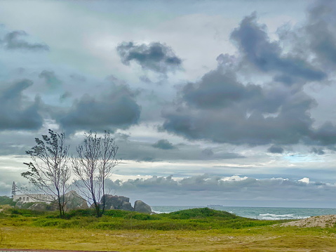 Beautiful beach landscape on a cloudy day with rain. Photo taken on Enseada beach, in beautiful São Francisco do Sul, Santa Catarina, Brazil.