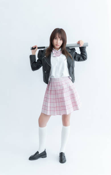 Asian school girl holding a bat