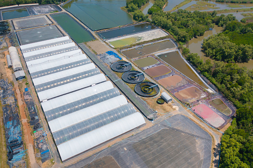 Aerial top view of metropolitan provincial waterworks industry factory in urban city town. Water utilities service.