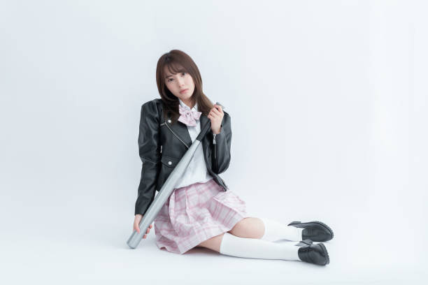 istock Asian school girl holding a baseball bat 1910119195