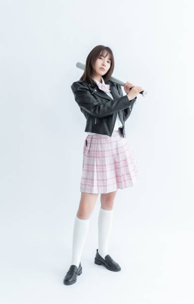 istock Asian school girl holding a bat 1910119725