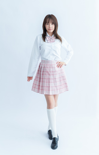 Asian school girl in white shirt and pink plaid skirt