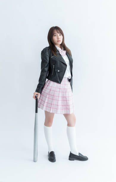 istock Asian school girl holding a baseball bat 1910127415