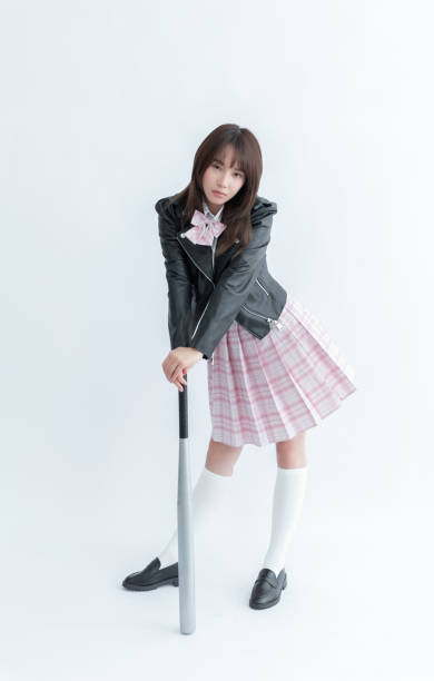 istock Asian school girl holding a baseball bat 1910131152