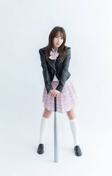 istock Asian school girl holding a bat 1910131691