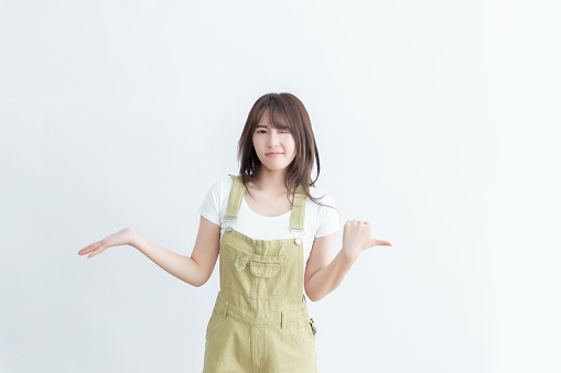 Young Asian woman in casual outfit gesturing with hands