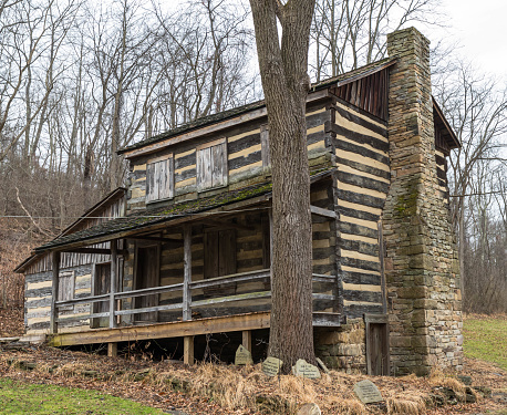 Plum, Pennsylvania, USA December 22, 2023 The Carpenter Log Cabin, a historical home in Boyce Park as seen on a winter day
