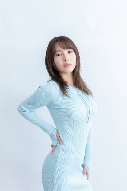 istock A woman in a blue dress posing with hands on hips 1910156766