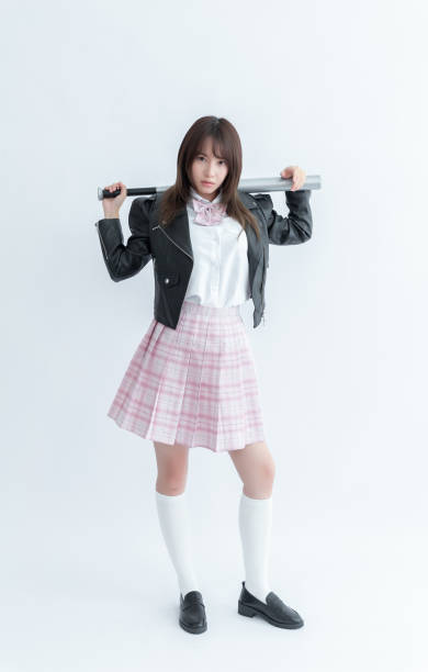 Asian school girl holding a baseball bat