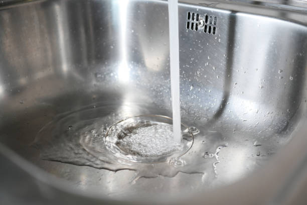 istock Water dripping from faucet tap at kitchen. Closeup 1910163850